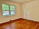 Bedroom with hardwood floors, natural lighting, and white walls at 1713 S Garnett St, Henderson, NC 27536