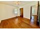 Spacious bedroom boasts hardwood floors, neutral paint, and natural light from windows at 1713 S Garnett St, Henderson, NC 27536