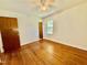 Cozy bedroom boasts hardwood floors, natural light, and a ceiling fan at 1713 S Garnett St, Henderson, NC 27536