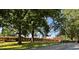 Exterior view of a brick building featuring mature trees at 1713 S Garnett St, Henderson, NC 27536