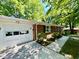 Side view of brick ranch home with an attached white two car garage at 1713 S Garnett St, Henderson, NC 27536