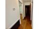 Hallway featuring hardwood floors and access to rooms at 1713 S Garnett St, Henderson, NC 27536