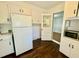 Functional kitchen includes refrigerator, microwave, and ample cabinet space at 1713 S Garnett St, Henderson, NC 27536