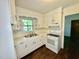 Well-lit kitchen featuring a double sink, range, and lots of storage at 1713 S Garnett St, Henderson, NC 27536