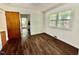 Room featuring light plank flooring, double windows, and white walls at 1713 S Garnett St, Henderson, NC 27536