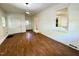 Light and airy room with brick accent wall, white doors and light plank flooring at 1713 S Garnett St, Henderson, NC 27536