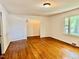 Bright living room with gleaming hardwood floors and large windows at 1713 S Garnett St, Henderson, NC 27536