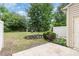This fenced backyard features established landscaping, a small retaining wall, and a concrete patio area at 172 Token House Rd, Durham, NC 27703