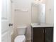 A clean bathroom featuring a vanity with dark cabinets, a toilet, and a shower-tub combination with a showerhead at 172 Token House Rd, Durham, NC 27703