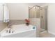 Bathroom featuring a soaking tub and separate glass-enclosed shower at 172 Token House Rd, Durham, NC 27703