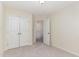 This bedroom features neutral carpet and walls, with white doors and trim, creating a bright, versatile space at 172 Token House Rd, Durham, NC 27703