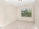 The bedroom features a bright window and neutral color palette with plush carpeting and a ceiling light fixture at 172 Token House Rd, Durham, NC 27703