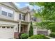 Charming townhouse with well-kept landscaping and a welcoming entrance and one-car garage at 172 Token House Rd, Durham, NC 27703