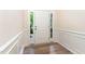 Bright foyer with white trim, sidelights, and wood-look flooring; a welcoming entrance to the home at 172 Token House Rd, Durham, NC 27703