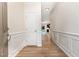 Welcoming foyer with neutral walls, white trim, and wood-look flooring, with an entry to the kitchen at 172 Token House Rd, Durham, NC 27703