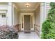 Inviting front porch featuring a brick foundation and a decorative welcome mat at 172 Token House Rd, Durham, NC 27703