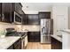 Modern kitchen with stainless steel appliances, granite countertops, and ample storage at 172 Token House Rd, Durham, NC 27703