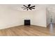 Bright living room featuring a fireplace, ceiling fan, and wood-look flooring at 172 Token House Rd, Durham, NC 27703