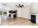 Open-concept living area with wood-look floors, fireplace, and views into the kitchen area at 172 Token House Rd, Durham, NC 27703