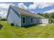 Expansive backyard featuring manicured lawn and a charming patio with a privacy fence at 1739 Old Fields Blvd, Haw River, NC 27258