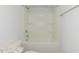 White shower/tub combo featuring built-in shelving and a granite vanity to the side at 1739 Old Fields Blvd, Haw River, NC 27258