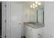 Bathroom features a granite vanity with a white base cabinet and a white framed mirror at 1739 Old Fields Blvd, Haw River, NC 27258