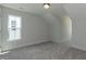 Empty bedroom features neutral carpet, a double-hung window, and an angled ceiling at 1739 Old Fields Blvd, Haw River, NC 27258