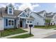 Charming two-story house featuring blue siding, dormer windows, and a single-car attached garage at 1739 Old Fields Blvd, Haw River, NC 27258