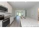Spacious kitchen featuring granite countertops, stainless appliances, and seamless access to the living room at 1739 Old Fields Blvd, Haw River, NC 27258