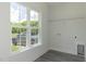 Bright laundry room features gray vinyl flooring, large windows, and washer/dryer hookups at 1739 Old Fields Blvd, Haw River, NC 27258