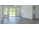 Bright living room with wood-look flooring and sliding glass doors to the outside at 1739 Old Fields Blvd, Haw River, NC 27258