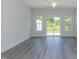 Bright living room with wood-look flooring and sliding glass doors to the outside at 1739 Old Fields Blvd, Haw River, NC 27258
