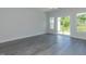 Bright living room with wood-look flooring and sliding glass doors to the outside at 1739 Old Fields Blvd, Haw River, NC 27258