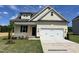 Charming single-Gathering home featuring a two-car garage and manicured lawn with fresh landscaping at 218 Oakdale Ave, Clayton, NC 27520