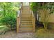 Backyard stairway surrounded by bushes and foliage at 2201 Mountain Mist Ct # 202, Raleigh, NC 27603