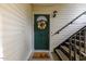 The townhome has a welcoming front door with a decorative wreath and a 'hello' mat at 2201 Mountain Mist Ct # 202, Raleigh, NC 27603