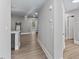Hallway featuring updated flooring and easy access to kitchen and bedrooms at 2201 Mountain Mist Ct # 202, Raleigh, NC 27603