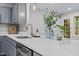 A kitchen with a quartz countertop features a sink with a modern faucet at 2201 Mountain Mist Ct # 202, Raleigh, NC 27603
