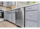 Modern kitchen with stainless steel dishwasher, sleek countertops, and neutral-toned cabinetry at 2201 Mountain Mist Ct # 202, Raleigh, NC 27603