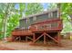 Exterior view of the home showcasing a multi-level deck and lush backyard at 2300 Cowden Ct, Raleigh, NC 27612