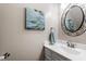 Half bathroom with white vanity, elegant mirror, and stylish decor at 2300 Cowden Ct, Raleigh, NC 27612