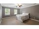 Bedroom with neutral colors, carpet, and windows overlooking the yard at 2300 Cowden Ct, Raleigh, NC 27612