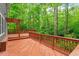 Large wooden deck with a pergola overlooking a lush, wooded backyard at 2300 Cowden Ct, Raleigh, NC 27612