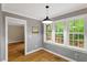 Well-lit dining room with large windows and hardwood floors at 2300 Cowden Ct, Raleigh, NC 27612