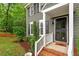Close-up of the front door with gray siding, and manicured landscaping at 2300 Cowden Ct, Raleigh, NC 27612