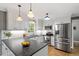 Bright kitchen featuring white cabinets, stainless steel appliances, and a beautiful stone countertop at 2300 Cowden Ct, Raleigh, NC 27612