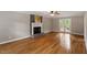 Spacious living room with hardwood floors and a fireplace with a brick hearth at 2300 Cowden Ct, Raleigh, NC 27612