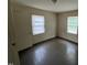 A simple bedroom with windows bringing in natural light and hardwood floors at 246 Keene St, Henderson, NC 27536