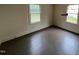 Neutral bedroom with hardwood floors, natural light, and two windows at 246 Keene St, Henderson, NC 27536