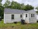 Rear view of a single-story home featuring horizontal siding and lawn at 246 Keene St, Henderson, NC 27536